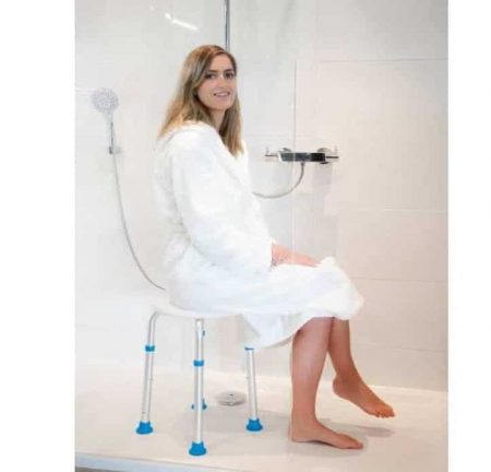 a woman sitting on the Atlantis Shower Stool